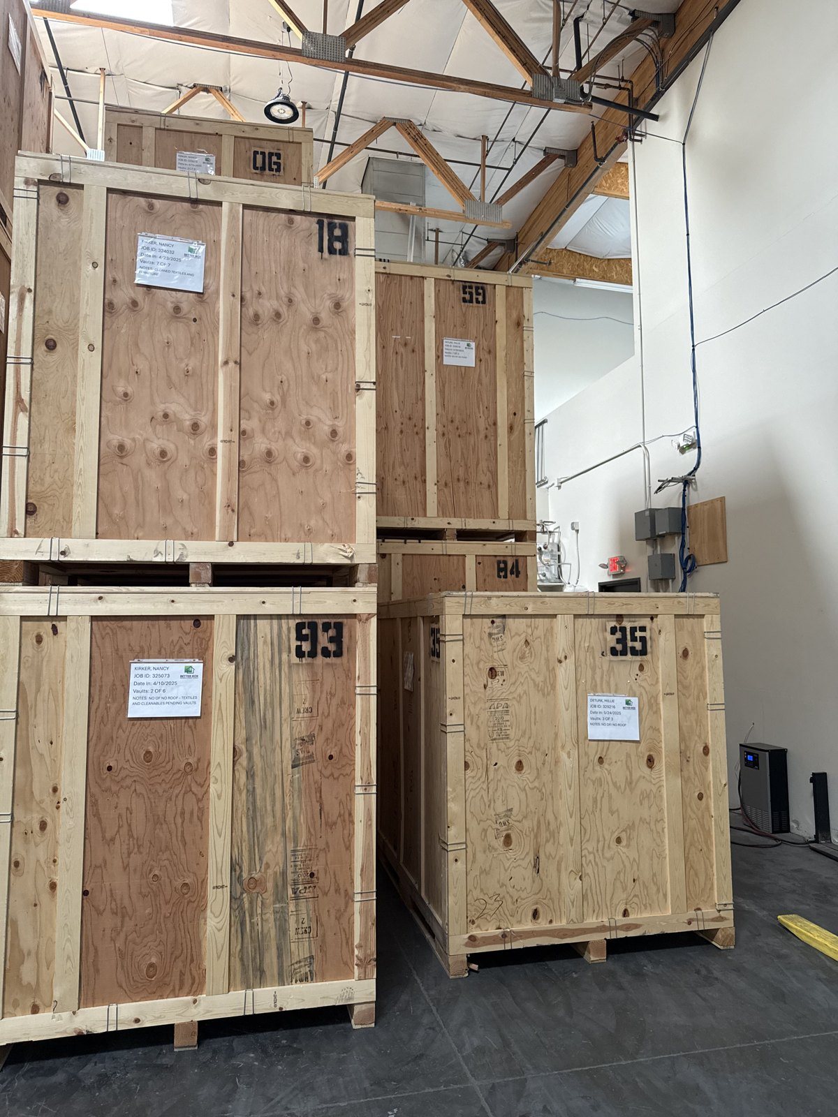 Contents being packed out of a damaged home in protective crates